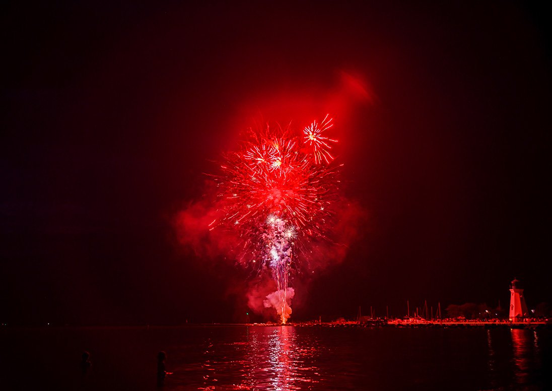 Red fireworks light up the night sky July 1, 2023 during Lakeside Long Weekend.