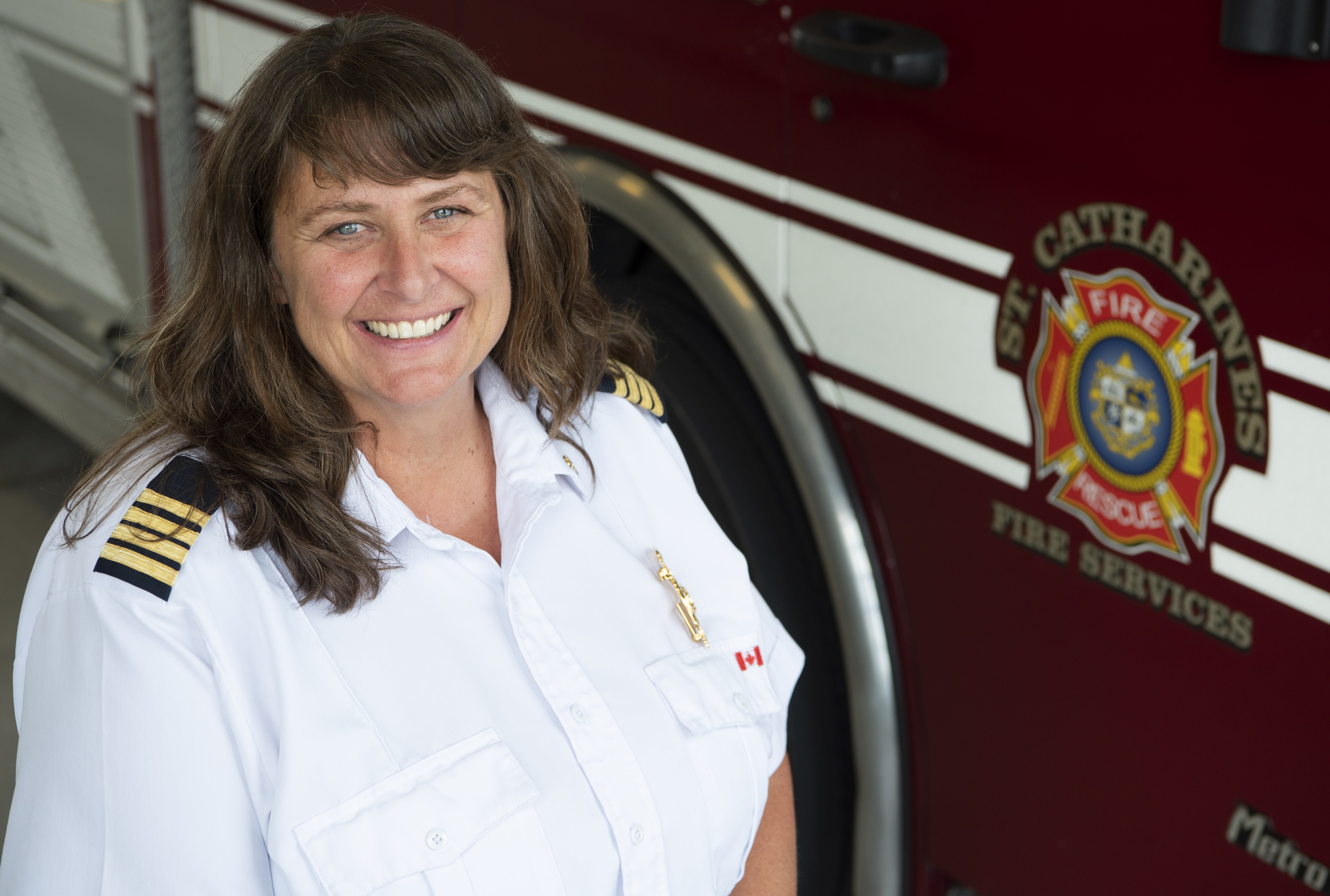 St. Catharines Fire Services Deputy Chief Andrea DeJong stands beside a St. Catharines Fire Services' fire truck.