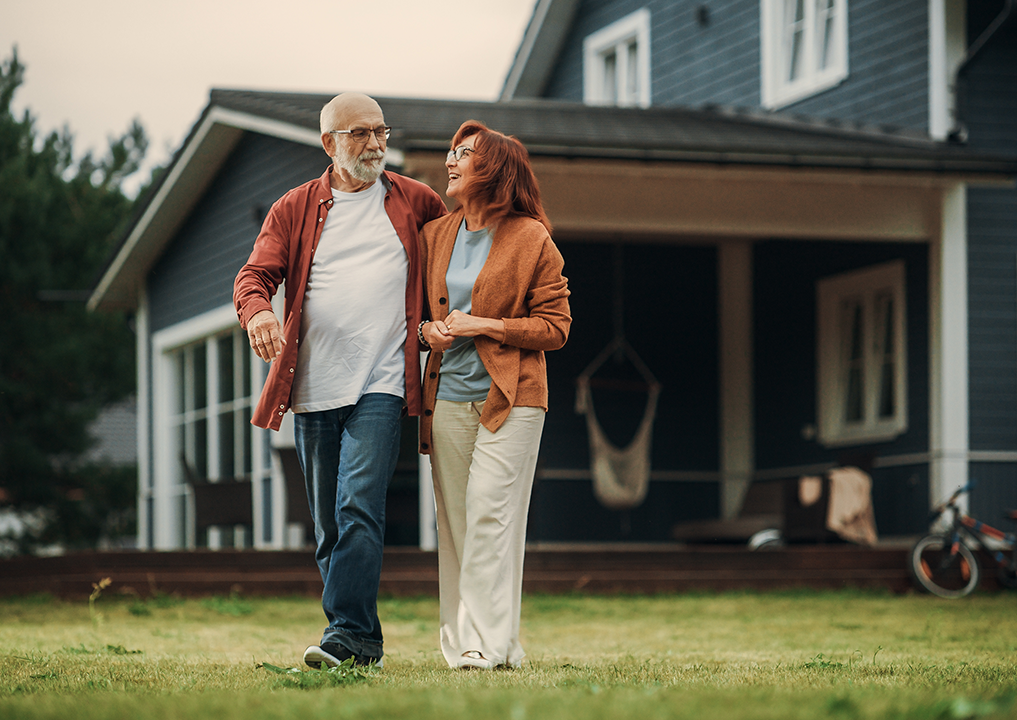 Older couple in front of home