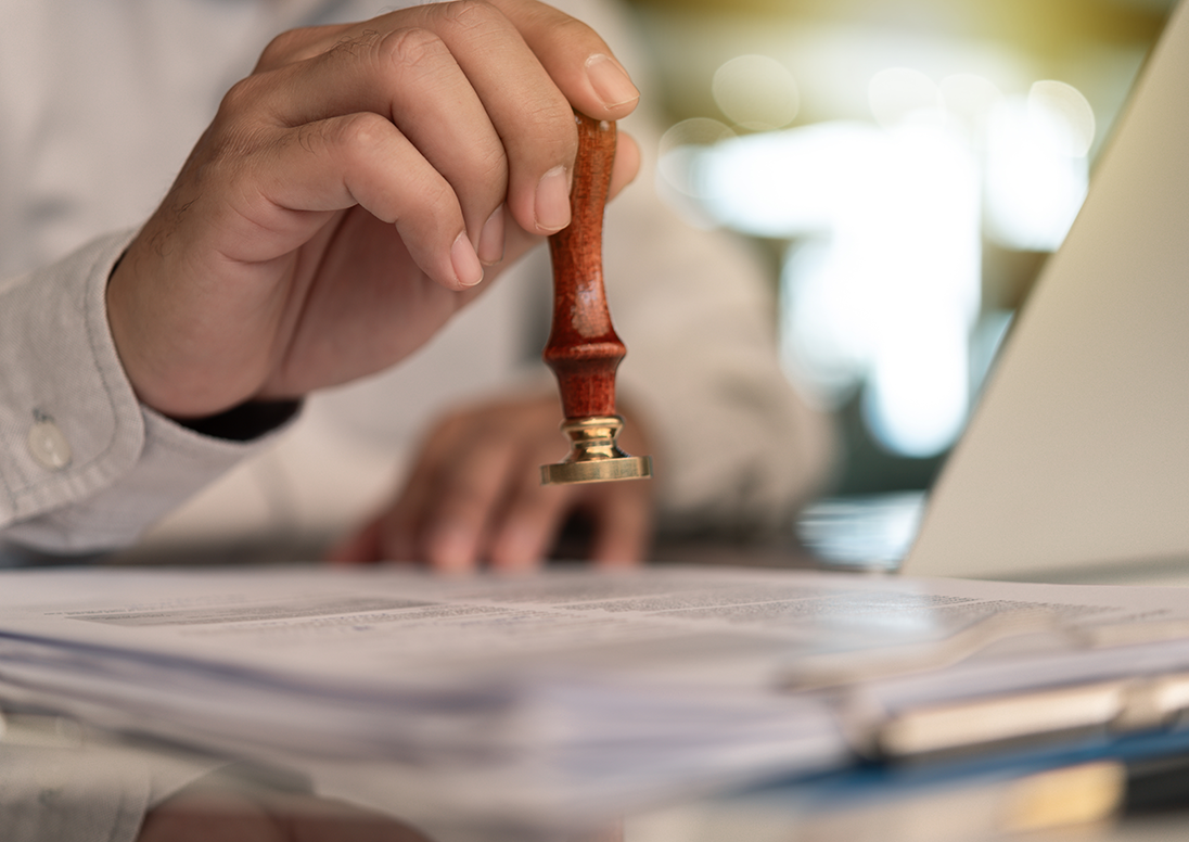 A hand stamping a document