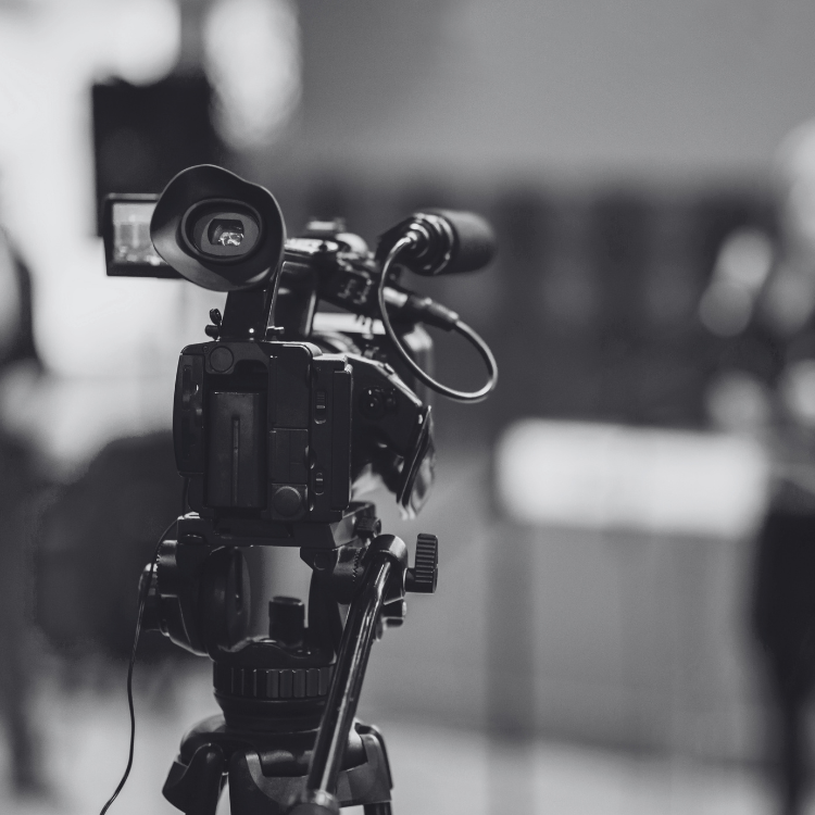 black and white photo of a camera for a media interview